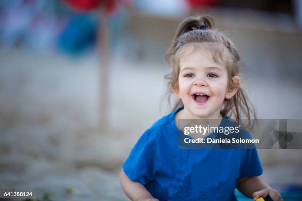 cute girl enjoying sand on the beach - 2 girls 1 sandbox stock pictures, royalty-free photos & images