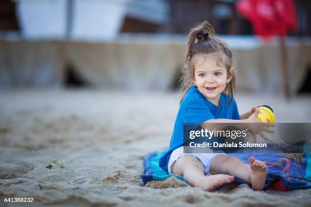 cute girl enjoying sand on the beach - 2 girls 1 sandbox stock pictures, royalty-free photos & images