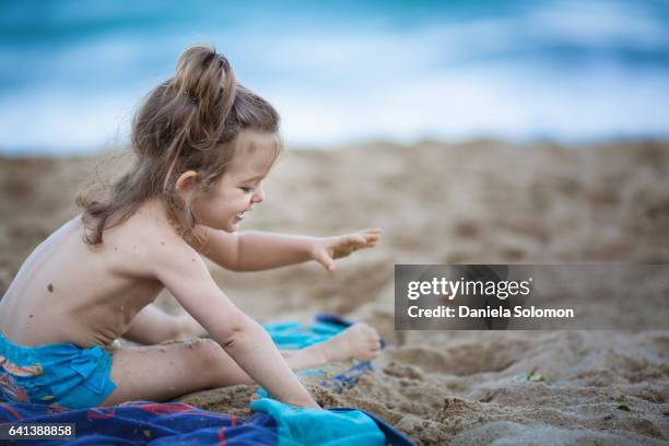 cute girl enjoying sand on the beach - 2 girls 1 sandbox stock pictures, royalty-free photos & images