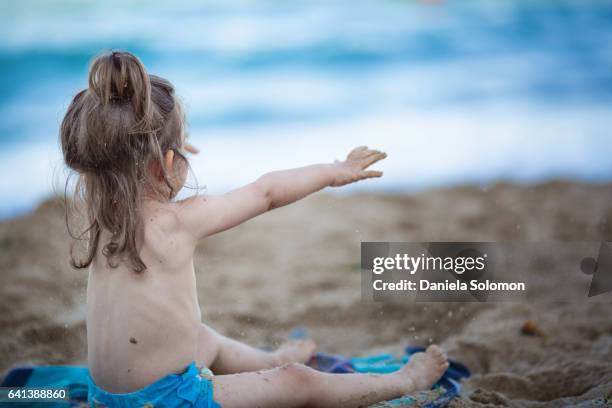 cute girl enjoying sand on the beach - 2 girls 1 sandbox stock pictures, royalty-free photos & images