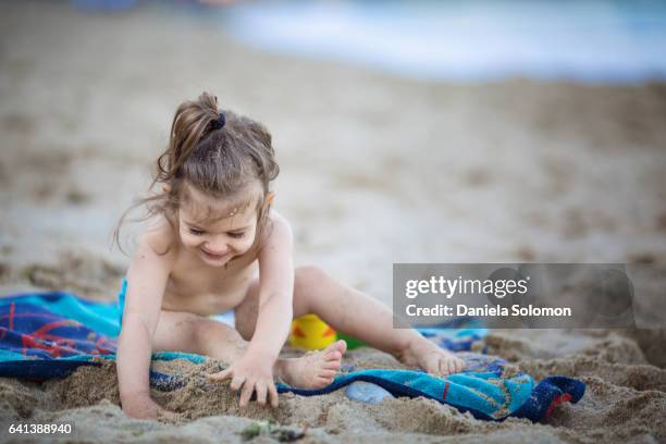 cute girl enjoying sand on the beach - 2 girls 1 sandbox stock pictures, royalty-free photos & images