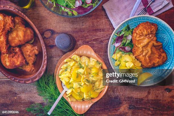 eating wiener schnitzel - fried potato stock pictures, royalty-free photos & images