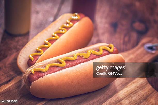 hot dogs with mustard - hot dog stock pictures, royalty-free photos & images