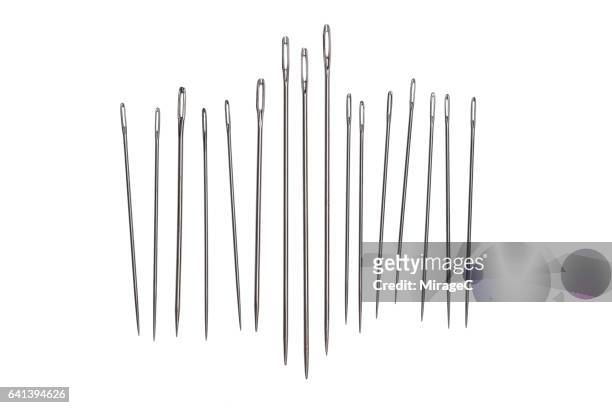 sewing needles on white background - sewing needle stock pictures, royalty-free photos & images
