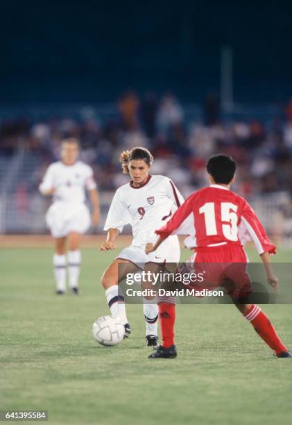 Mia Hamm of the United States plays in a match against China on July 27, 1998 during the 1998 Goodwill Games at the Nassau County Mitchel Athletic...