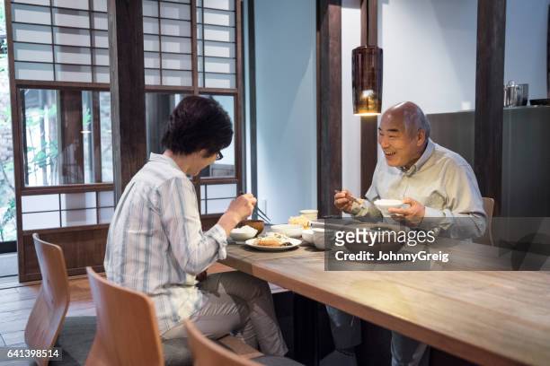 japanese couple enjoying meal together at home - only japanese stock pictures, royalty-free photos & images