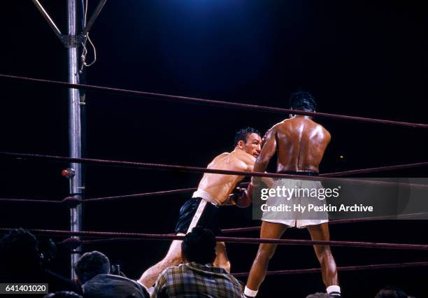 Carmen Basilio punches Sugar Ray Robinson during the World Middleweight Title Fight on September 23, 1957 at Yankee Stadium in the Bronx, New York.