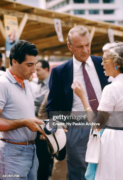 Driver Alfonso "Marquis' de Portago talks with actor Gary Cooper before the Grand Prix of Cuba race on February 24, 1957 in Havana, Cuba.