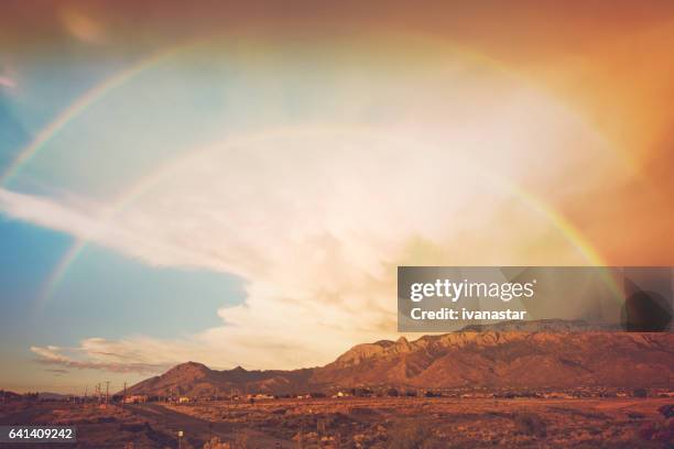 double rainbow after a storm, with sandia mountains in background - double rainbow stock pictures, royalty-free photos & images