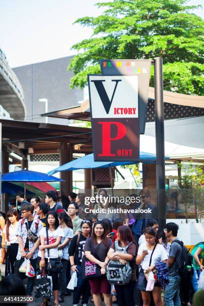 waiting thai people at victory monument - verkehrswesen stock pictures, royalty-free photos & images