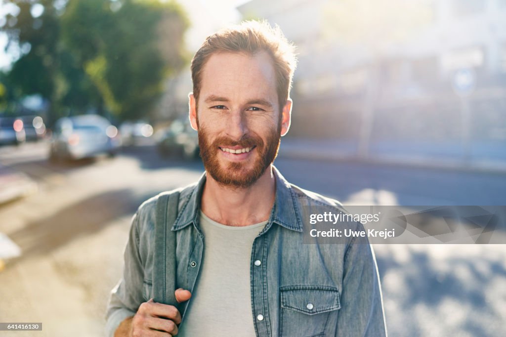 Smiling young man on the street