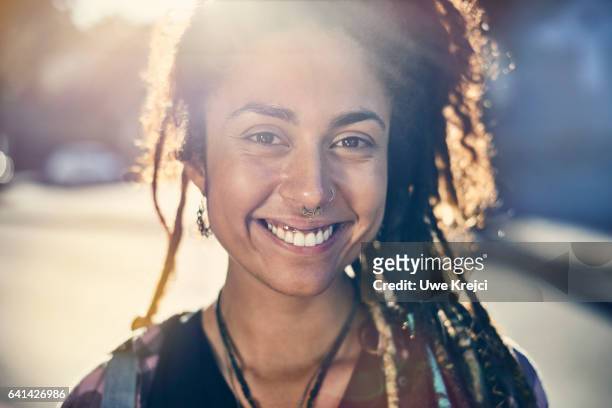 portrait of young pierced woman with dreadlocks - leanincollection ストックフォトと画像