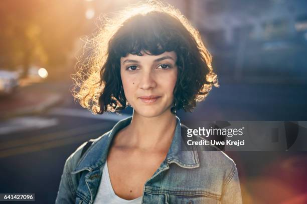 portrait of young woman in the city - personaggio foto e immagini stock
