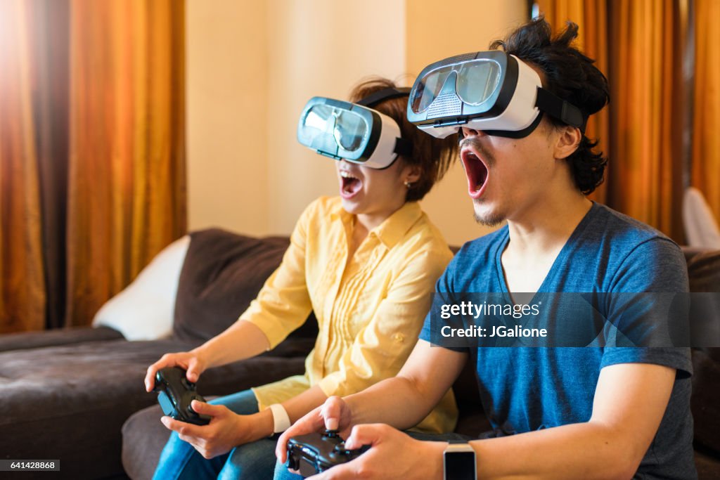 Young couple playing virtual reality games together
