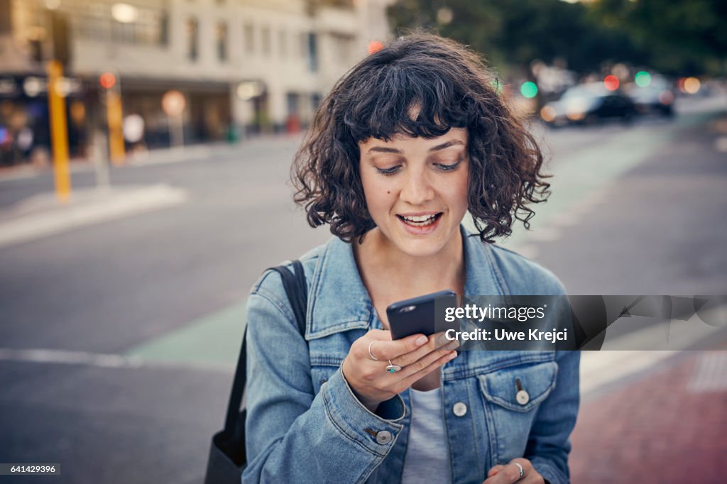 Young woman with smart phone in the city