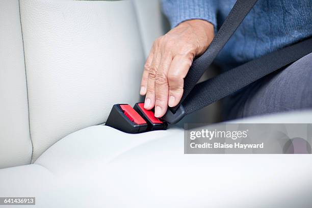 woman fastening seatbelt - seat belt stock pictures, royalty-free photos & images