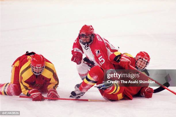 Danielle Goyette of Canada competes against Wang Wei and Li Xuan of China in the Ice Hockey Women's First round between Canada and China during day...