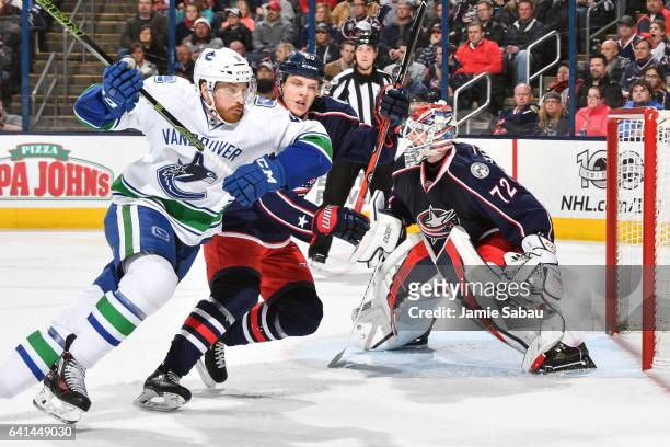 Jack Skille of the Vancouver Canucks and Markus Nutivaara of the Columbus Blue Jackets chase after a loose puck on February 9, 2017 at Nationwide...