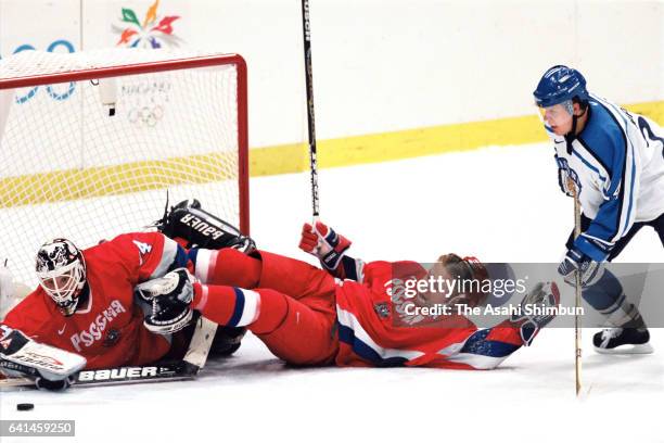 Darius Kasparaitis and goalie Andrey Trefilov of Russia defend during the Ice Hockey Men's Group D match between Russia and Finland during day eight...