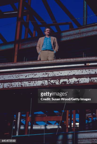 Portrait of Canadian-American architect Frank Gehry as he stands amid steel I-beams at the construction site of one of his buildings, Santa Monica,...