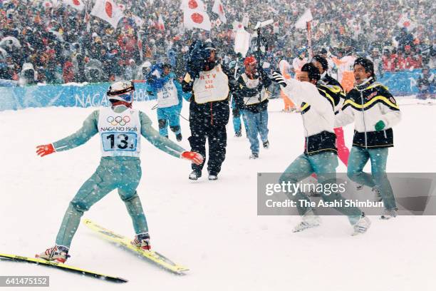 Kazuyoshi Funaki, Masahiko Harada, Takanobu Okabe and Hiroya Saito of Japan celebrate winning the gold medals in the Ski Jumping Team during day ten...