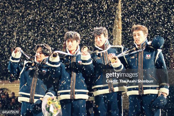 Gold medalists Takanobu Okabe, Hiroya Saito, Masahiko Harada and Kazuyoshi Funaki of Japan celebrate on the podium at the medal ceremony for the Ski...