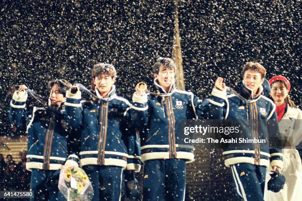 Gold medalists Takanobu Okabe, Hiroya Saito, Masahiko Harada and Kazuyoshi Funaki of Japan celebrate on the podium at the medal ceremony for the Ski...