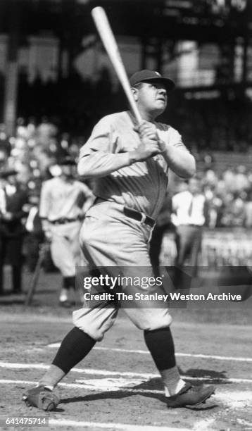 New York Yankees, Babe Ruth swinging his bat and follows flight of one of his home runs, circa 1925.