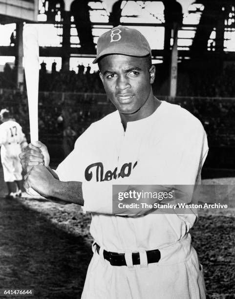 Jackie Robinson of the Brooklyn Dodgers poses for a portrait with his bat, circa 1947 Jackie