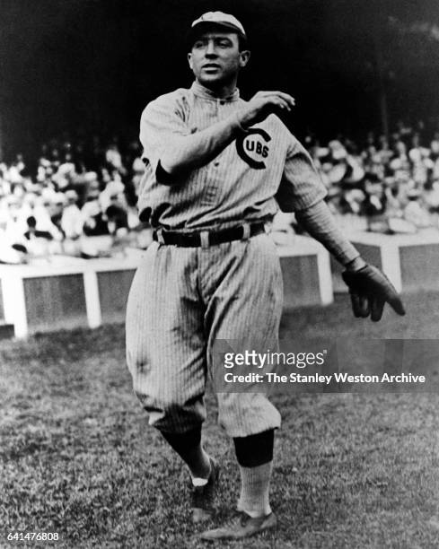 Joe Tinker, shortstop for the 1910 Chicago Cubs, in full on the road uniform, throws the ball, circa 1910.