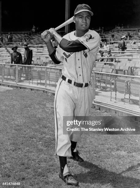 Larry Doby, centerfielder of the Cleveland Indians, poses for a portrait swinging his bat prior to a game in the year 1951.