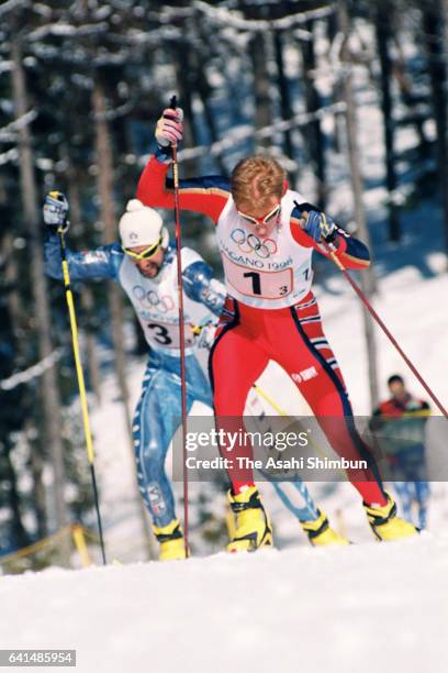 Bjorn Daehlie of Norway and Fabio Maj of Italy compete in the Cross Country Skiing Men's 4x10km Relay during day eleven of the Nagano Winter Olympic...