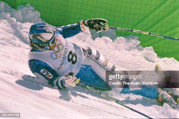 Alberto Tomba of Italy falls while competing in the Alpine Skiing Men's Giant Slalom during day twelve of the Nagano Winter Olympic Games at Mt....
