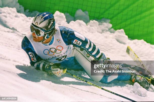 Alberto Tomba of Italy falls while competing in the Alpine Skiing Men's Giant Slalom during day twelve of the Nagano Winter Olympic Games at Mt....