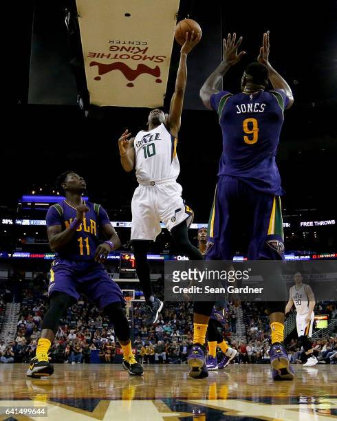 Alec Burks of the Utah Jazz shoots over Terrence Jones of the New Orleans Pelicans during a game at the Smoothie King Center on February 8, 2017 in...