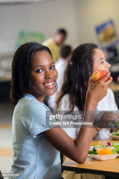 beautiful african american private high school student in school cafeteria - high school cafeteria stock pictures, royalty-free photos & images
