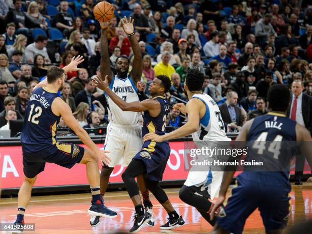 Lance Stephenson of the Minnesota Timberwolves passes the ball away from Donatas Motiejunas and Buddy Hield of the New Orleans Pelicans during the...