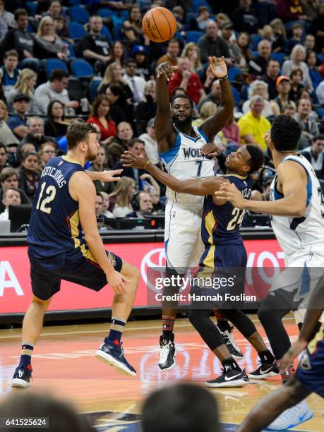 Lance Stephenson of the Minnesota Timberwolves passes the ball away from Donatas Motiejunas and Buddy Hield of the New Orleans Pelicans during the...