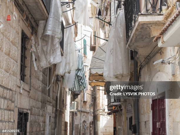 street scene in the old town of bari, with sails covered laundry on balconies - as bari stock pictures, royalty-free photos & images