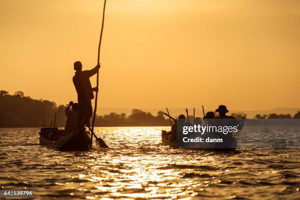 traditional fishing pirogue at sunset on the tsiribihina river in madagascar - dugout canoe stock pictures, royalty-free photos & images