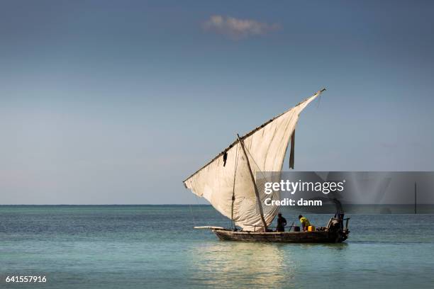 traditional fisherman dhow boat during the day, zanzibar, tanzania - dhow stock pictures, royalty-free photos & images