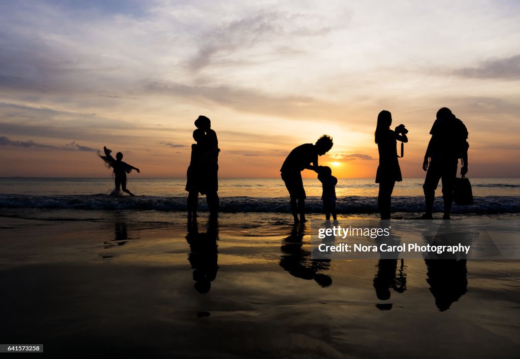 Silhouettes at the beach duing sunset