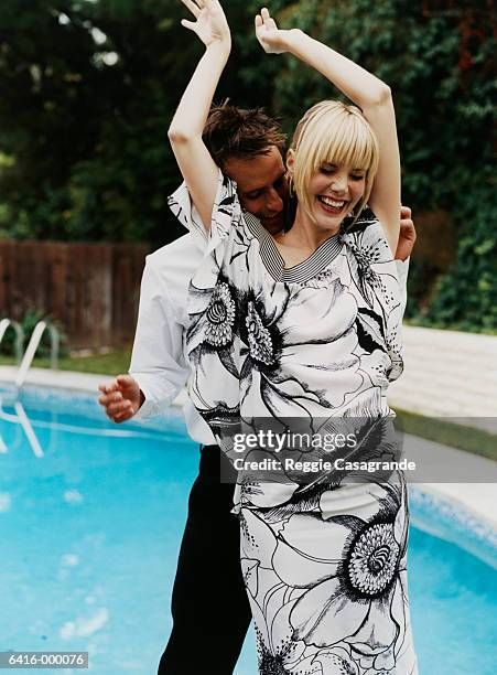 couple dancing by pool - man in dress foto e immagini stock