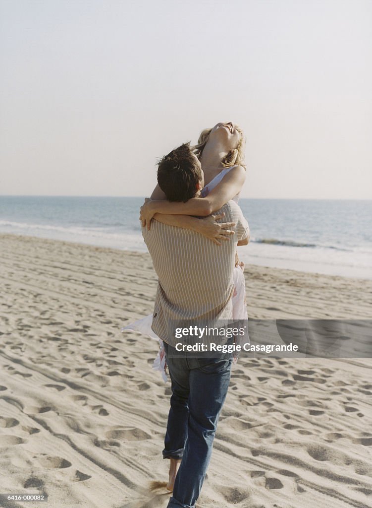 Man Hugging Woman on Beach