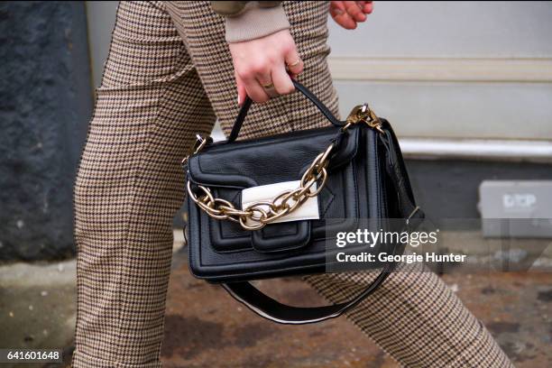 Guest is seen at Spring Studios outside the Lacoste show wearing brown and beige checked suit pants, brown leather jacket and black leather bag with...