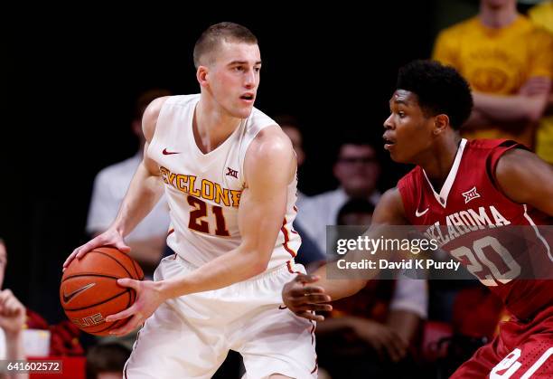 Matt Thomas of the Iowa State Cyclones looks to pas the ball as Kameron McGusty of the Oklahoma Sooners puts pressure on in the second half of play...