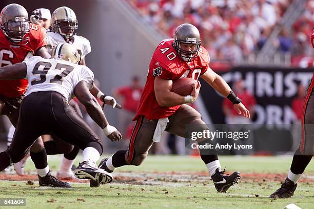 Mike Alstott of the Tampa Bay Buccaneers evades the defense of the New Orleans Saints during the game at Raymond James Stadium in Tampa, Florida. The...