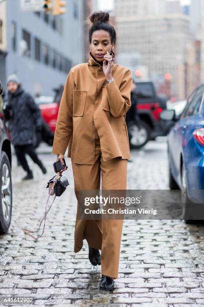 Jan-Michael Quammie wearing a brown jacket and pants outside Lacoste on February 11, 2017 in New York City.