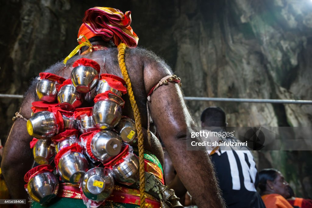 Devotee with pierced body as act of devotion. Tamil community celebrates Hindu festival Thaipusam