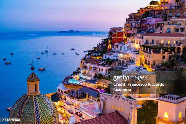 positano, amalfi coast, campania, sorrento, italy. view of the town and the seaside in a summer sunset - positano italy stock pictures, royalty-free photos & images